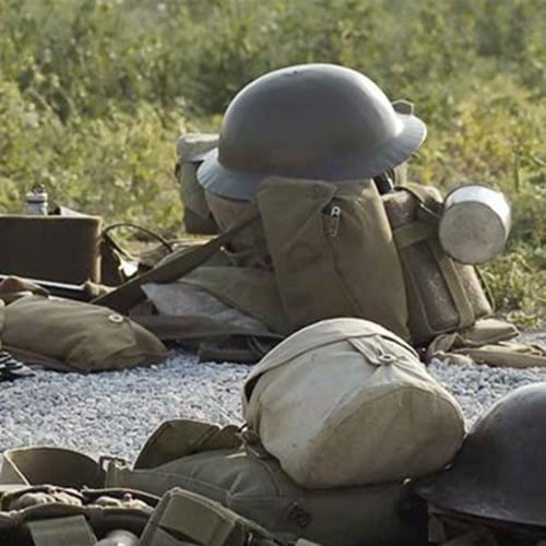 Military tin hat on military gear and webbing
